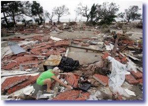 Woman picks through the rubble of her home after Hurricane Katrina